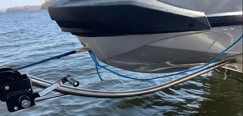 The curved winch arm with the winch at the top, and the strap running level to the bow eye
